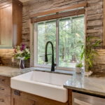 The large farmhouse sink and high-end fixtures are additional samples of the quality finishes in the whole-house remodel.