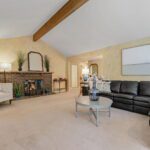 Extra large family room with a high-vaulted ceiling and a timeless exposed beam