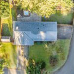 The aerial view show just how expansive the land is! One driveway to the 2 car garage, the second space is the RV parking space. Notice how wide and deep the lot is, including the large shed and back yard including the hot tub.