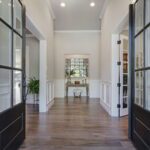 From the moment you walk through the French entry doors, you are immediately greeted by the highest level of craftsmanship and finishes. To the right is a large office with closet for use as a bedroom if desired. To the left is the inviting dining room, conveniently located next to the kitchen