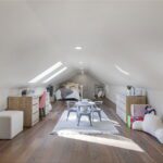 Steps leading to the open loft area with skylights.