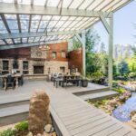 A bridge over the water feature as a transition between the outdoor covered living spaces.